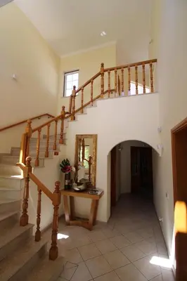 a staircase in a house with a mirror and a table at Charming Exceptional Golf Villa in Algarve in Faro
