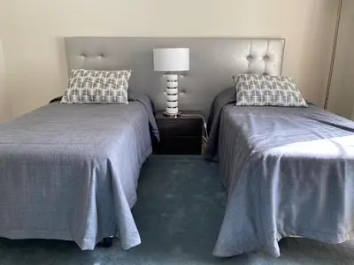 two beds sitting next to each other in a room at Charming Exceptional Golf Villa in Algarve in Faro
