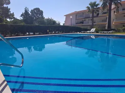 a large blue swimming pool in front of a building at Nautilus 135- Clever Details in Vilamoura