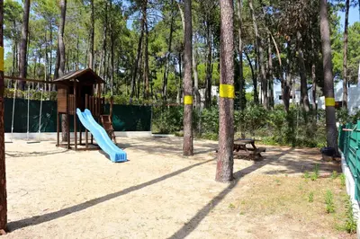 a playground with a blue slide and a bench at Nautilus 135- Clever Details in Vilamoura