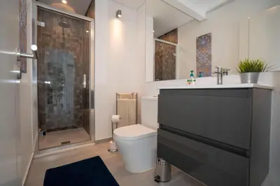 a bathroom with a toilet and a sink and a shower at Paradise Quarteira in Quarteira