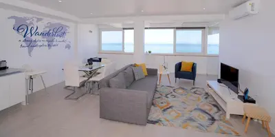 a living room with a couch and a tv at Paradise Quarteira in Quarteira