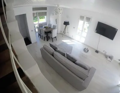 a living room with a couch and a table at Vilamoura in Vilamoura