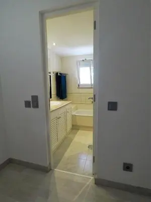a white bathroom with a tub and a sink at Vilamoura in Vilamoura