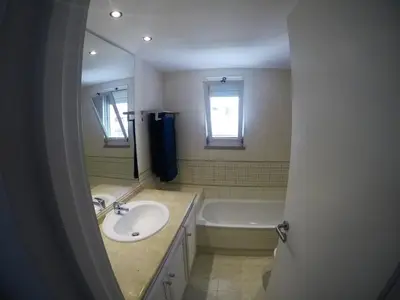 a bathroom with a sink and a bath tub at Vilamoura in Vilamoura