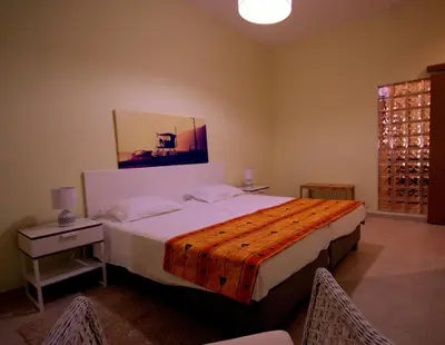 a bedroom with a bed and a table and chairs at Apartamentos Plaza - Albufeira in Albufeira