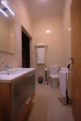 a bathroom with a sink and a toilet at Apartamentos Plaza - Albufeira in Albufeira
