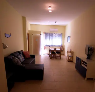 a living room with a couch and a table at Apartamentos Plaza - Albufeira in Albufeira