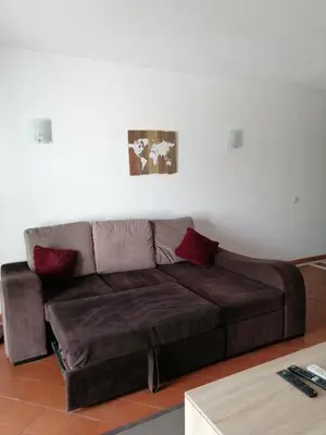 a brown couch sitting in a living room at apartamento em albufeira in Albufeira