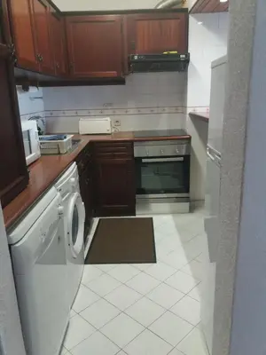 a kitchen with a washer and dryer in it at apartamento em albufeira in Albufeira