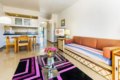 a living room with a couch and a table at Tropical Sol in Albufeira