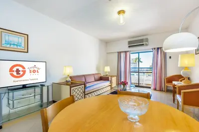 a living room with a table and a couch at Tropical Sol in Albufeira