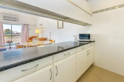 a kitchen with a counter top and a dining room at Tropical Sol in Albufeira