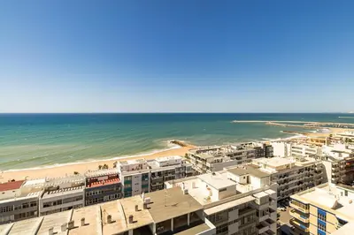 an aerial view of the beach and buildings at Torres Mira Praia by Garvetur in Quarteira