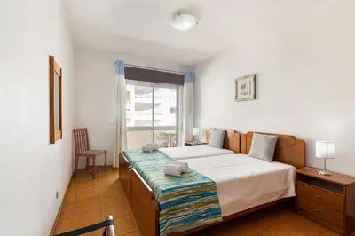 a bedroom with a bed and a window at Paula Bela by Garvetur in Quarteira
