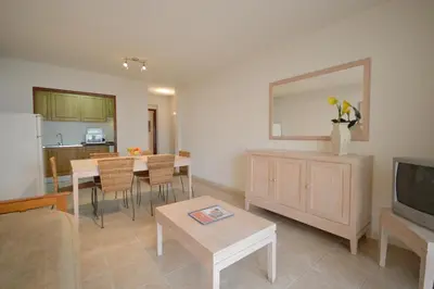 a living room with a couch and a table and a tv at Paula Bela by Garvetur in Quarteira