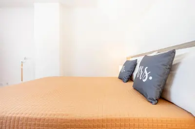 a bedroom with a bed with two pillows on it at My Place @ Faro Duplex in Faro