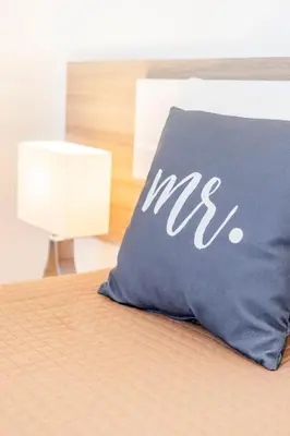 a pillow with the msg written on it sitting on a bed at My Place @ Faro Duplex in Faro