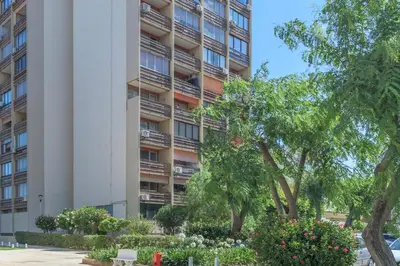 an apartment building with trees and flowers in front of it at FLH Vilamoura Cozy Studio in Vilamoura