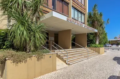 a building with stairs and palm trees in front of it at FLH Vilamoura Cozy Studio in Vilamoura
