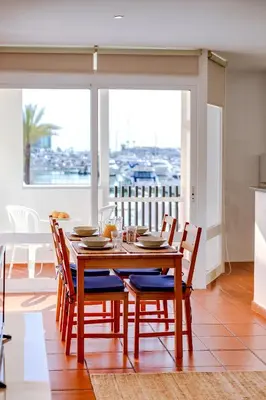 a dining room with a wooden table and chairs at AL - Apartamento Vista Marina 1 in Vilamoura
