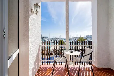 a balcony with a table and chairs and a view at AL - Apartamento Vista Marina 2 in Vilamoura