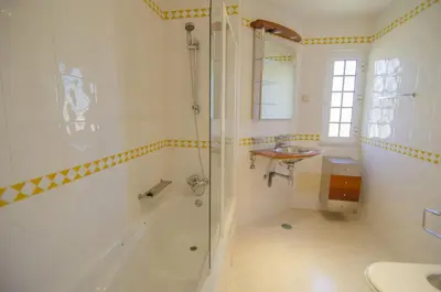a bathroom with a sink and a tub and a toilet at Villa Lira in Almancil