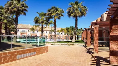a courtyard with palm trees and a building at Villa Jardins 2 by Sunny Deluxe in Albufeira