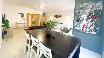 a living room with a black table and white chairs at Villa Jardins 2 by Sunny Deluxe in Albufeira