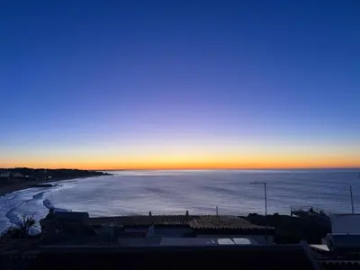 a bedroom with a bed with a view of the ocean at Apartamentos Rossio Mar in Albufeira