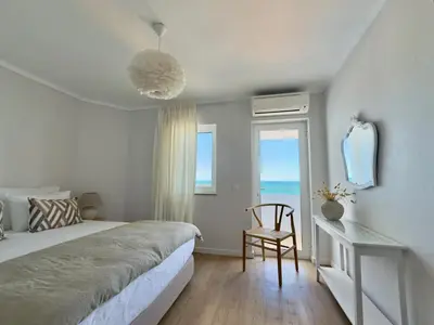 a group of chairs and umbrellas sitting on a balcony at Apartamentos Rossio Mar in Albufeira