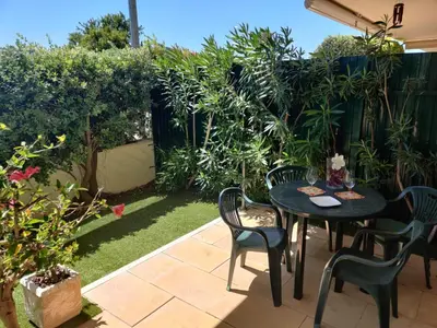 a patio with a table and chairs and plants at Albufeira Monte Balaia in Albufeira