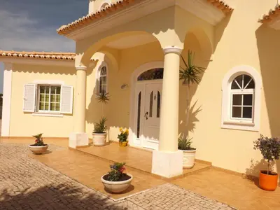 a house with a front door and columns at Villa Estrelamar in Boliqueime
