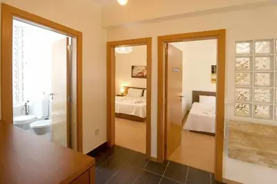 a room with a bedroom with a bed and a bathroom at Hiva T3 By FHR in Vilamoura