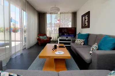 a living room with a couch and a coffee table at Hiva T3 By FHR in Vilamoura