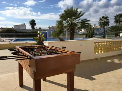 a foosball table on a patio next to a pool at Moradia Galé in Guia