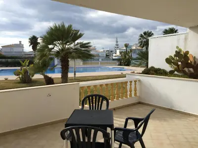a balcony with a table and chairs and a swimming pool at Moradia Galé in Guia