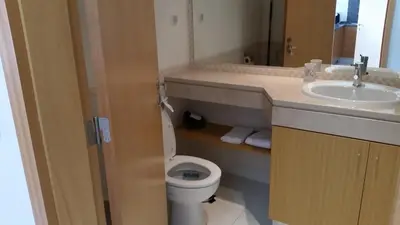 a bathroom with a toilet and a sink at Vista das Ondas Olhos de Agua in Albufeira
