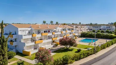 an aerial view of an apartment complex with a swimming pool at T1 Grevilias em Vilamoura - Greice Homes in Quarteira