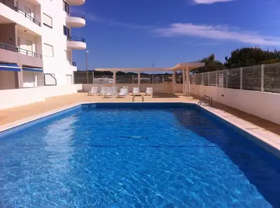 a swimming pool on the roof of a building at Quarteira T1 - Oceanides in Quarteira