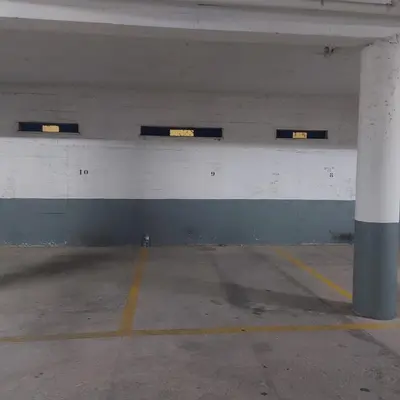 an empty parking garage with lights on the wall at Quarteira T1 - Oceanides in Quarteira