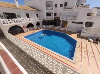 an apartment with a swimming pool in a building at Apartamento Oura T1 Beach 200m in Albufeira