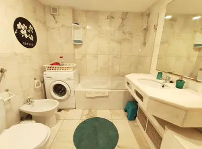 a bathroom with a toilet sink and a washing machine at Apartamento Oura T1 Beach 200m in Albufeira