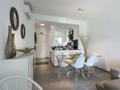 a kitchen and dining room with a table and chairs at Luxury 3 Bedroom Apartment, Albufeira Resort in Albufeira
