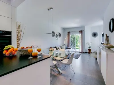 a kitchen and dining room with a table with fruit on it at Luxury 3 Bedroom Apartment, Albufeira Resort in Albufeira