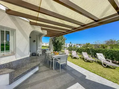 an outdoor patio with a table and chairs at Luxury 3 Bedroom Apartment, Albufeira Resort in Albufeira