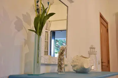 a vase sitting on a table in front of a mirror at Faro Beach House in Faro
