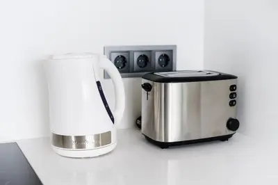 a coffee maker and a toaster on a counter at Casas Barulho Penthouse Old Town in Albufeira