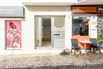 two chairs and a table outside of a store at Casas Barulho Penthouse Old Town in Albufeira