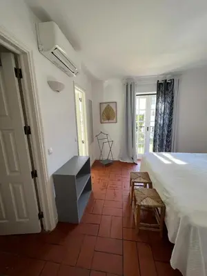 a bedroom with a bed and a table and chairs at T3 Townhouse Old Village Vilamoura in Vilamoura